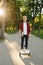 Young man riding on mini gyroboard in summer park