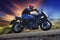 Young man riding motorcycle on curve of asphalt country road