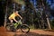 Young man riding a mountain bike downhill style