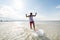 Young man riding on skimboard on summer beach