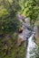 A young man riding on a zip line rope in an extreme adventure jungle in Xico, Veracruz, Mexico