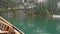 Young man rowing in boat on mountain lake