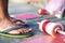 Young man with rubber slippers chappal with a charkhi fikri spool with dor thread with glass thread and kites placed