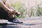 young man runner tying shoelaces