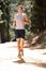 Young man running along country lane