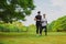 Young man running in the green park with friend