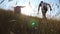 Young man running with his dog at green hill in nature. Labrador or golden retriever jogging with his owner at