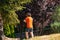 Young man running in the park in a sunny morning while listening to the music with wireless headphones in Dikmen Valley Park in