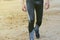 Young man running on sand quarry in summer in gray tights