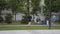 Young man runs along lawn near tranquil pond in city park