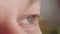 Young man's gray-green eyes, close-up