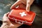 Young man\\\'s hand gripping a first aid kit