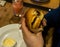 Young man`s hands are holding a bitten hamburger in a fast food restaurant