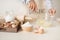 Young man`s hands whisk eggs with sugar to bake fruit cake. Male cooking dough for pie on white table