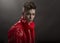 Young man`s portrait. Stylish handsome Guy in fashionable red Long lacquer raincoat, Close-up