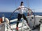 Young man sailing yacht steering wheel vacation sail