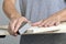 Young man sanding a wooden board with a sanding block