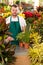 Young man scanning barcode flower shop gardening