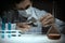 Young man scientist using auto-pipette with flask in medical science laboratory. Researcher concept.