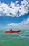 Young man in sea kayak under dramatic skies