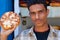 Young man sells traditional burned goat cheese at the market in Sanaa, Yemen.