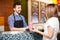 Young man serving food to a woman