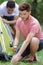 young man setting up camp tent for camping trip