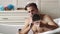 Young man shaving face near mirror in bathroom. Male beauty, beard care skincare concept.