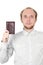 Young man in shirt showing his passport isolated