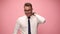 young man in shirt and tie on pink background