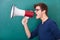 Young man shouting in megaphone