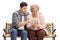 Young man showing elderly woman how to use mobile phone