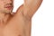 Young man showing hairy armpit on white background. Epilation procedure