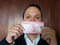 young man showing and holding a chilean banknote