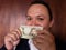 young man showing and holding a colombian banknote of 5000 pesos