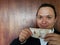 young man showing and holding a peruvian banknote of twenty soles