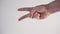 Young man shows with his hand the sign Peace or Victory on a white background