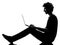 Young man silhouette sitting computing laptop