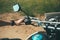 Young man sits behind the wheel of a motorcycle first-person view