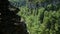 Young man sits in lotus position on top, looks down. Summer, sunny day, closeup