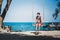 Young man sits on a rope swing on the beach on Ko Samet