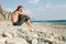 Young man sitting on the beach