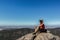 young man sitting on cliff at the Boroka Lookout, Grampians National Park, Australia