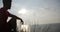 Young man sitting on the cliff and looking the sunset