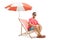 Young man sitting on a deckchair under an umbrella and smiling at the camera