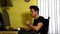 Young man sitting at desk at home using a computer