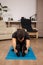 Young man sitting on the floor doing Paschimottanasana yoga pose