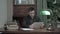 Young man sitting at his study table and having a video call via tablet