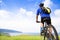 Young man sitting on a mountain bike and looking the ocean