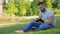 Young man sitting in the park with his diary